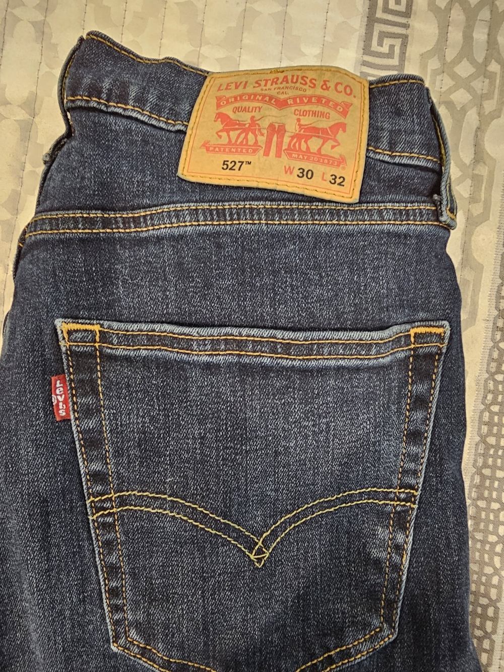 Levi's dark blue denim jeans with yellow stitching